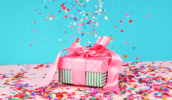 beautifully wrapped gift in pink with confetti