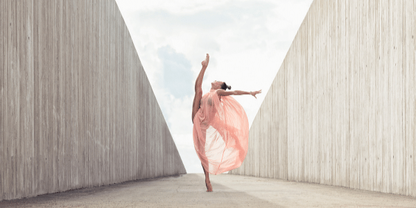 Lyrical dancer in flowy costume dancing on walkway